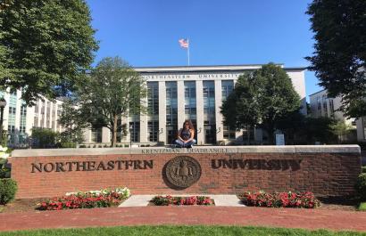 student at entrance of Northeastern University