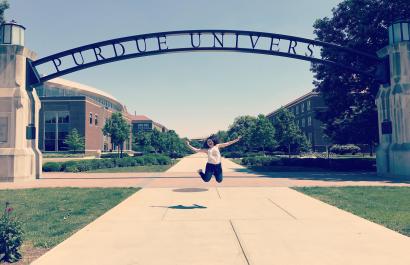 student at entrance of Purdue University