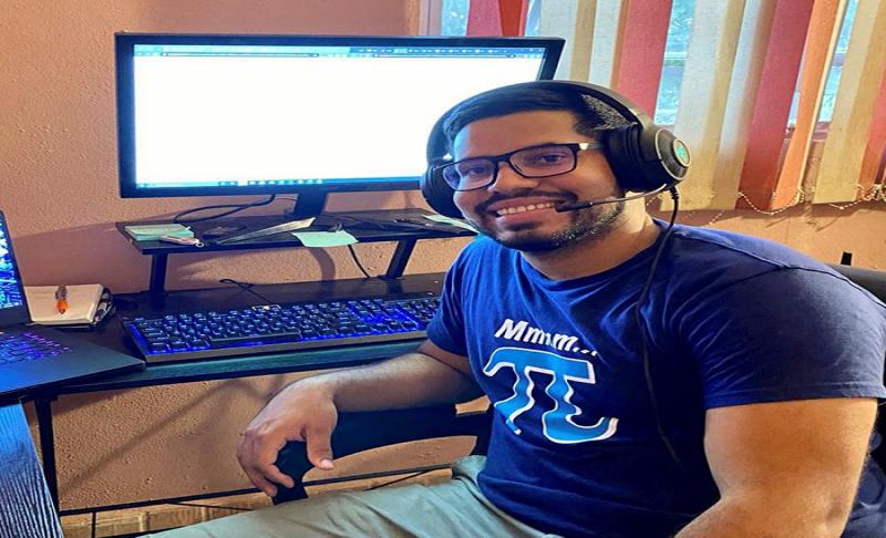 Foto delestudiante subgraduado Josué Martínez Martínez sentado frente a una computadora